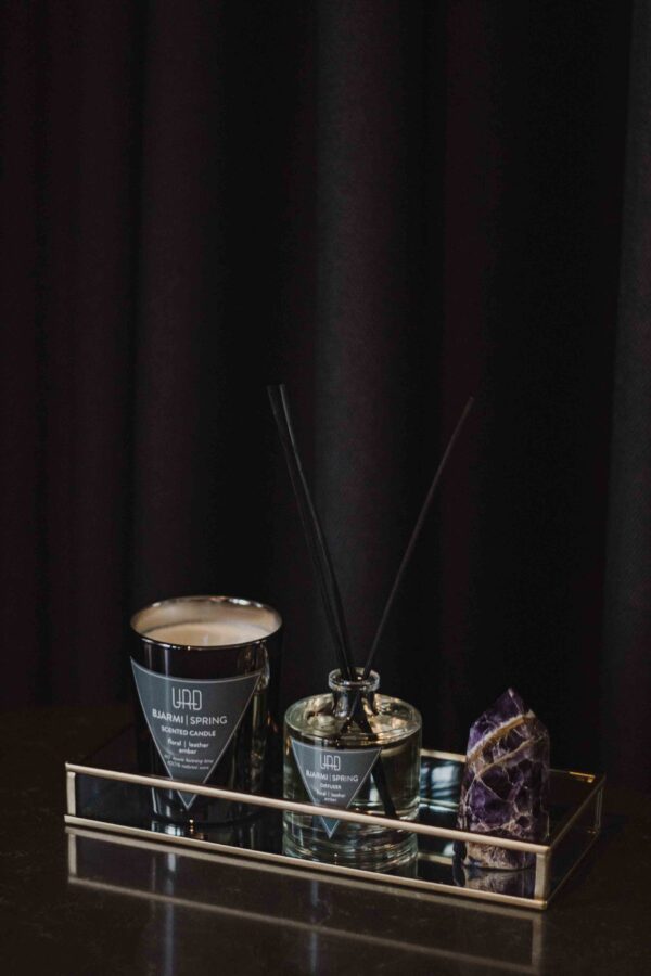 URÐ BJARMI home diffuser with black rattan sticks, featuring a warm spring scent of leather, flowers, and amber.