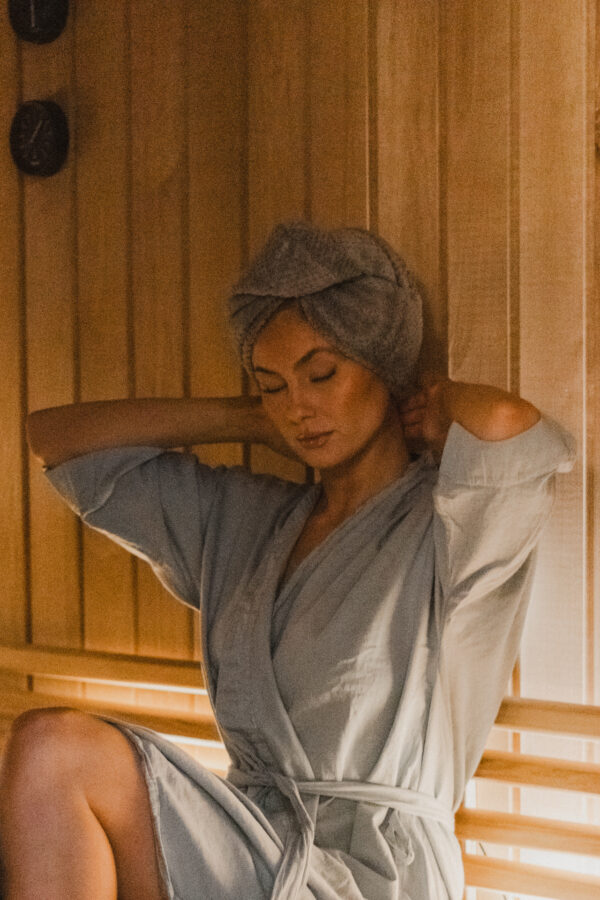 Soft and absorbent hair towel in pale blue, designed to quickly dry and reduce frizz on wet hair, perfect for after showering